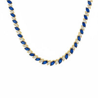 Gold tennis necklace with navy oval stones in a linked row