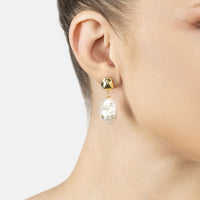 Gold-tone teardrop pearl drop earrings with baroque studs on the ear