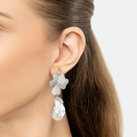 Clip-on earrings: silver glitter flower with white pearl drop, worn on ear