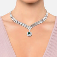 Silver rhinestone choker necklace with emerald center pendant and round emblem charm