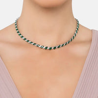 Emerald-green oval-stone tennis necklace on neckline, silver-tone chain
