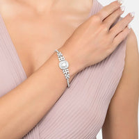 Silver gemstone bracelet on wrist with marquise links and central radiant-cut stone