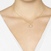 Gold chain necklace with small hexagon evil eye pendant on neckline