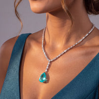 Silver necklace with turquoise teardrop pendant and crystal detailing