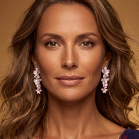 Pink and silver cherry blossom drop earrings worn on ear, dangling flower clusters
