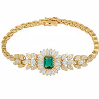Gold bracelet with emerald center stone and pavé leaf accents