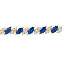 Row of gold tennis bracelet with blue oval gemstones and clear stones