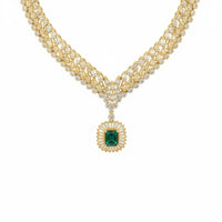 Gold-tone statement necklace with emerald pendant and rhinestone chain
