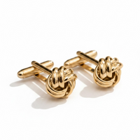 Gold-tone knot cufflinks with bar posts and round coiled knot front