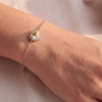 Silver bracelet with small oval yellow gemstone on a fine chain