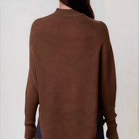 Back view of brown high-neck jumper with batwing sleeves and asymmetric hem