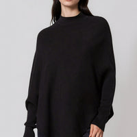 Black high-neck jumper with batwing sleeves and asymmetric side hem
