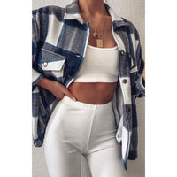 White pants with elastic waistband, worn with a navy-and-white plaid overshirt