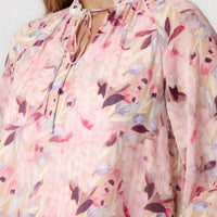 Pink floral tie-neck blouse with pleated neckline, sheer blouson sleeves