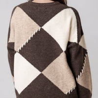 Wool-blend jumper back view in cream and dark argyle diamonds with zigzag hem detail