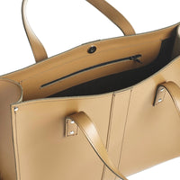 Leather shopper interior with dark lining, zip pocket, and adjustable shoulder strap