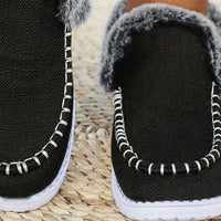 Black faux fur lined round toe slip-on shoes, close-up of interior and stitching