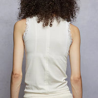 Cream cropped tank top with round neck and lace trim at neckline and armholes