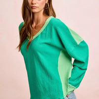 Textured jersey color block top, emerald green with light green patch on upper sleeve