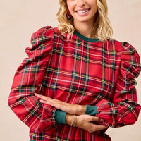 Red plaid top with puff shoulders and green crew neck, long sleeves