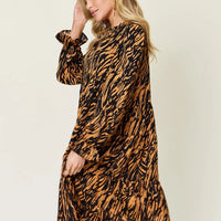 Caramel and black printed long-sleeve ruffle-tier midi dress, side view