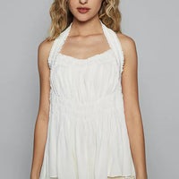 Off-white halter sleeveless top with ruched smocking detail and scalloped hem
