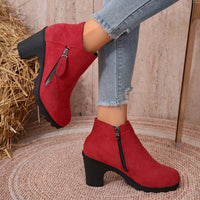 Red suede block-heel ankle boots with round toe and zippered side entry