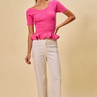 Hot pink ribbed knit peplum sweater top with short sleeves, front view on model