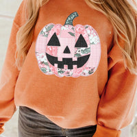 Orange sherbet tunic sweatshirt with round neck and large patchwork jack-o'-lantern graphic