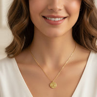 Gold zodiac pendant necklace with round Aries medallion charm on fine chain