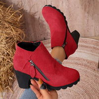 Red suede ankle boots with block heel, round toe, and side zipper detail