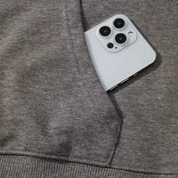 Dark gray hoodie sleeve and pocket area with ribbed cuff; smartphone beside