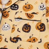 Gold Halloween-print long-sleeve top close-up, sleeve cuff and button placket