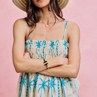 Blue palm-print smocked cami top with adjustable straps and tiered peplum hem
