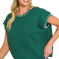 Hunter green oversize knit sweater with contrasting stitch trim at neckline and sleeve hems