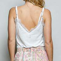 Women's off-white lace-trim V-neck cami with thin spaghetti straps, back view