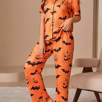 Orange Halloween pajama lounge set with pumpkin and bat print, button-front short-sleeve top