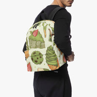 Kids canvas backpack worn by model, green food print on front and black straps