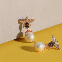 Bee drop earrings set with pear-shaped pearl drops and crystal wings