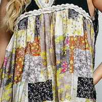 Close-up: black sheer floral V-neck tank with white lace trim and patchwork print
