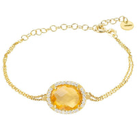 Gold oval gemstone bracelet with citrine center and crystal halo accents