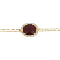 Gold bracelet with oval garnet gemstone and crystal halo