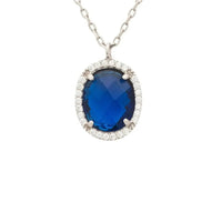 Silver necklace with oval blue gemstone pendant in sparkling halo, cable chain
