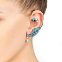 Turquoise bird ear climber earring on right ear, gold-tone hook with crystal details