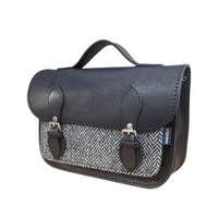 Black leather and tweed midi satchel side view with front clasp and strap