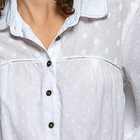 Off-white textured shirt neckline with button placket and tonal dots