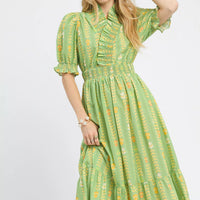 Sage green smocked midi dress with puff sleeves and ruffled neckline, patterned print