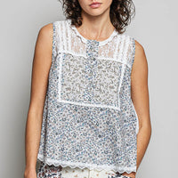 Off-white sleeveless woven lace round-neck top with blue floral print and scalloped hem