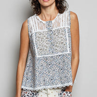 Off-white sleeveless woven lace round-neck top with blue floral paneling and scalloped hem