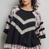 Black oversized knit top, round neck, contrast chevron lace, floral ruffle hem trim